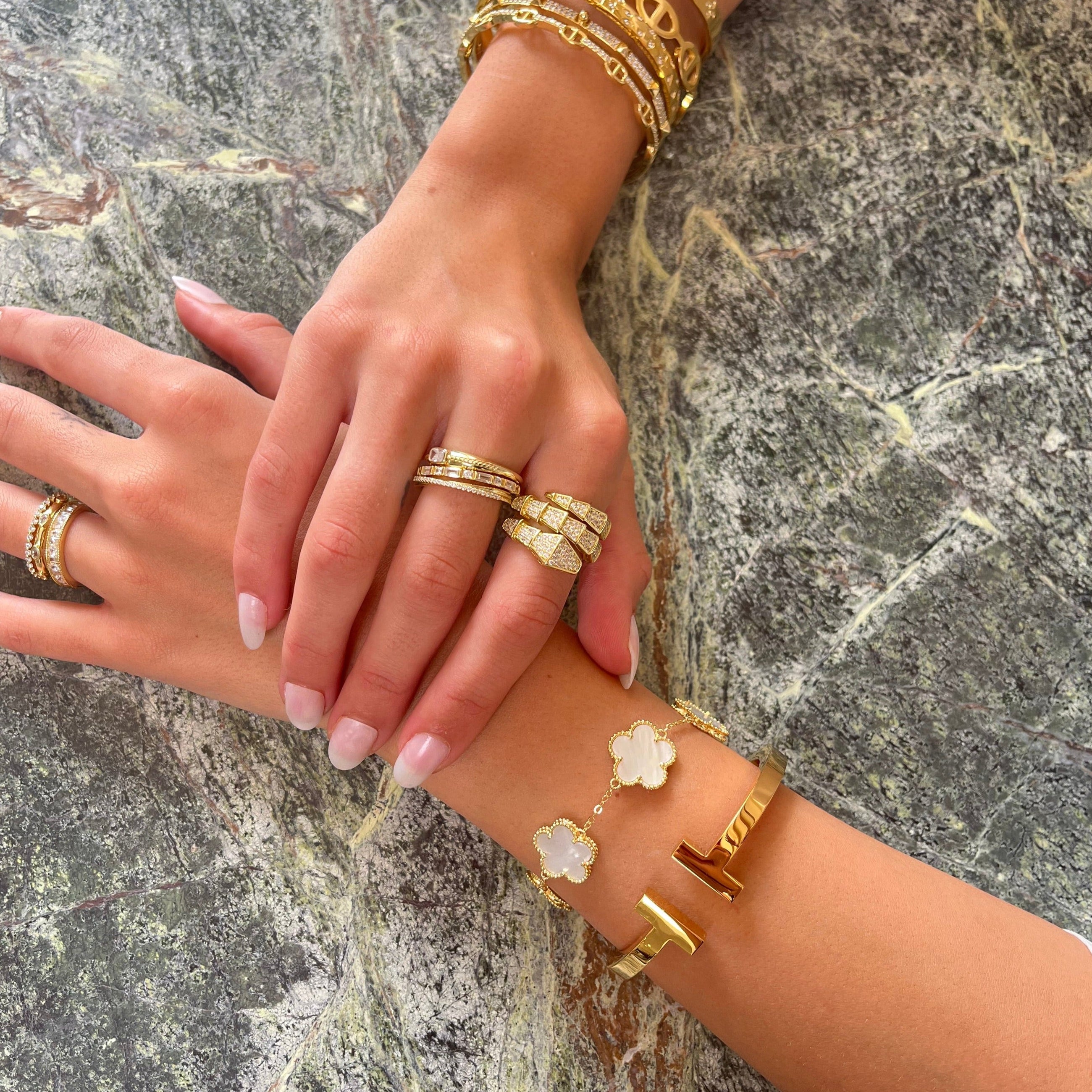 Adjustable clover bracelet layered with bangles