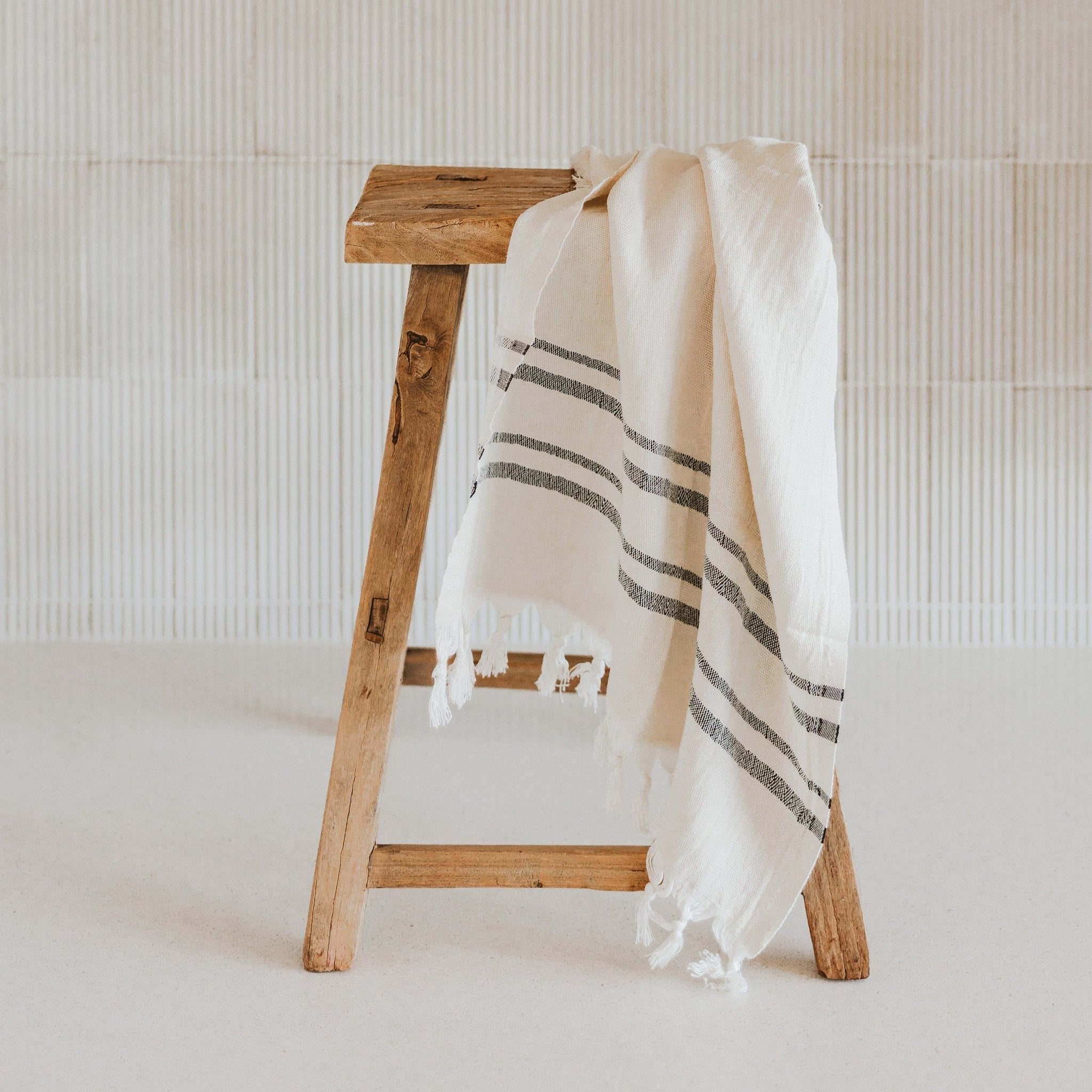 Handwoven natural towel draped in kitchen setting