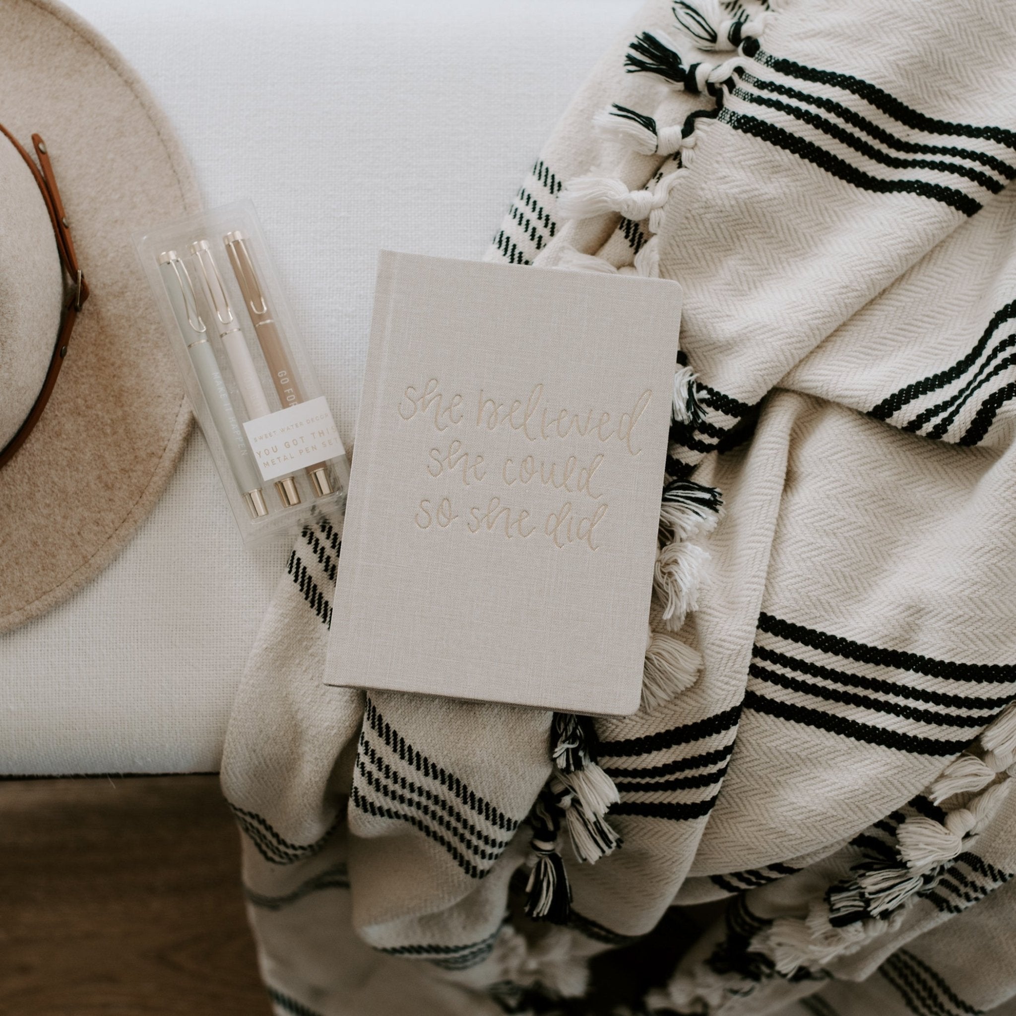 Fabric cover journal styled on desk with pens