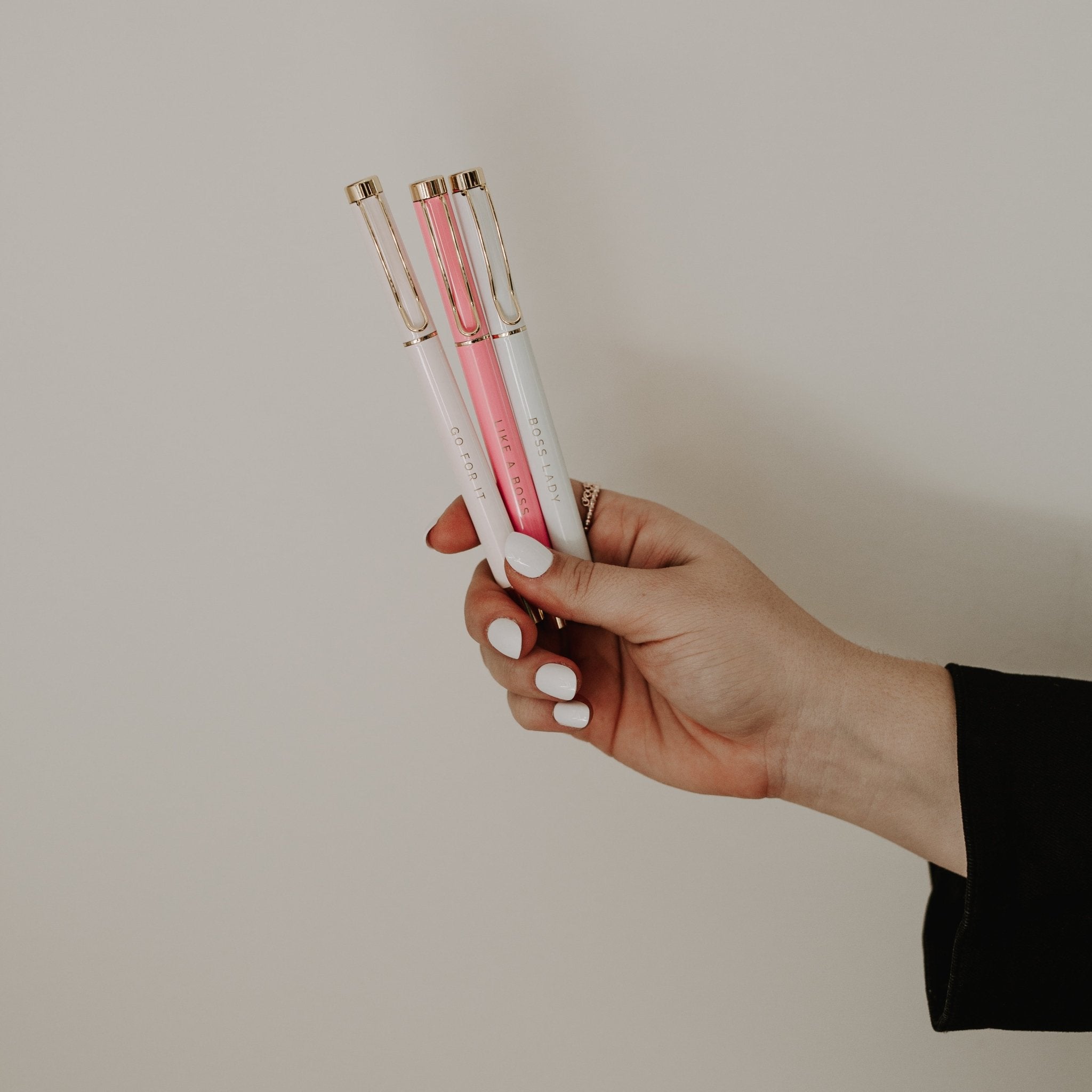 White and pink ballpoint pens with inspirational text