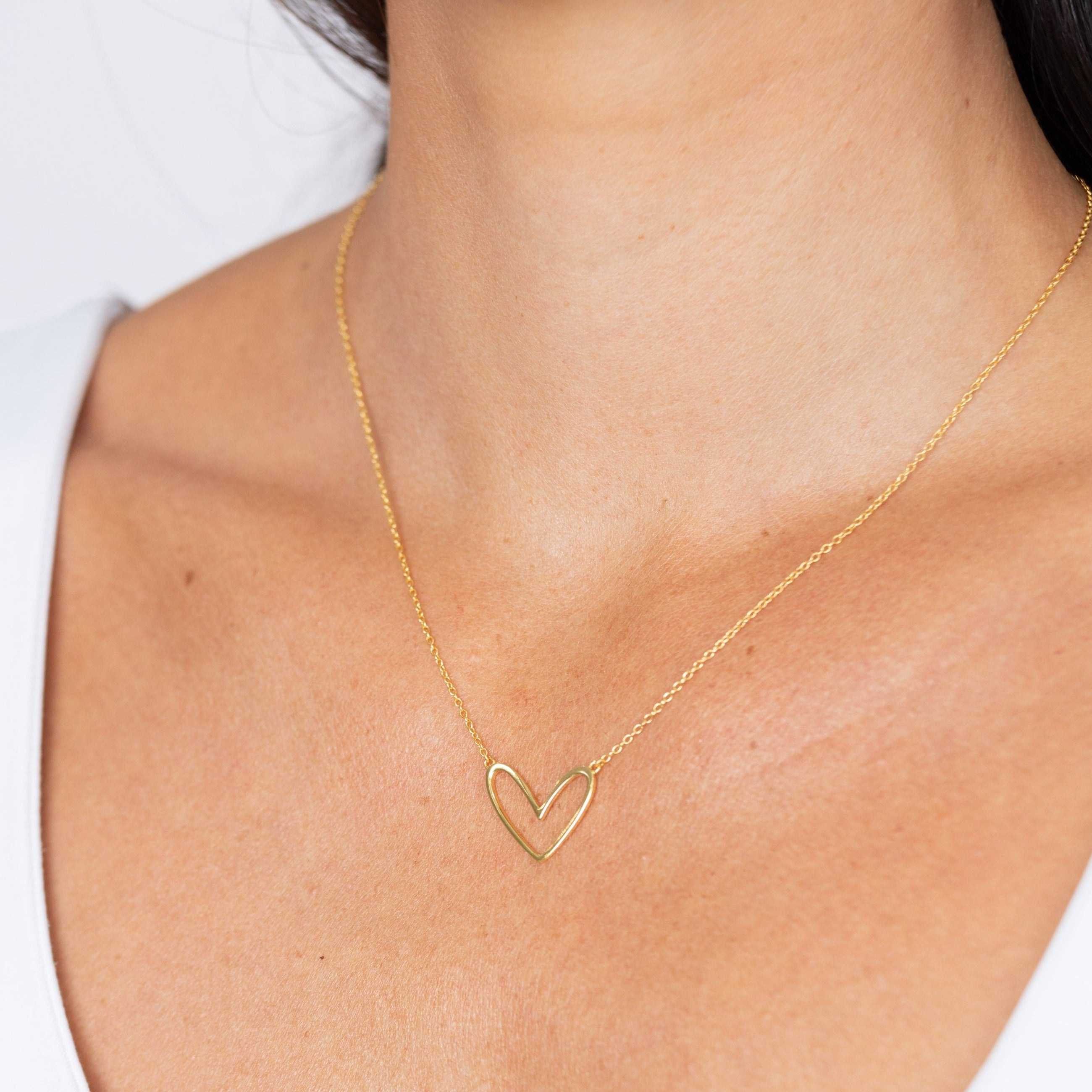 Gold plated heart necklace styled on model
