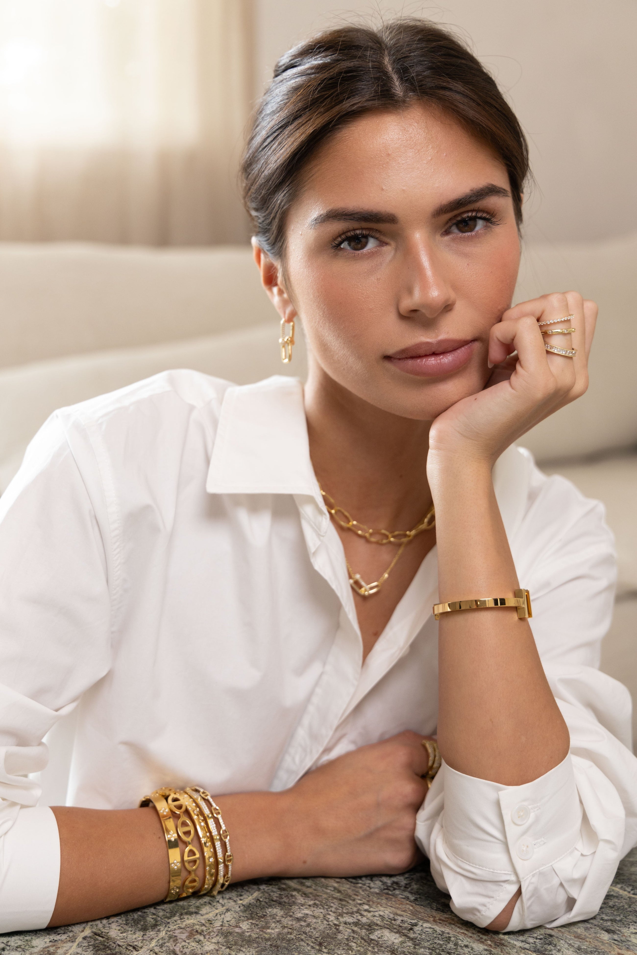 Gold-plated Ivy CZ rings styled with minimalist jewelry