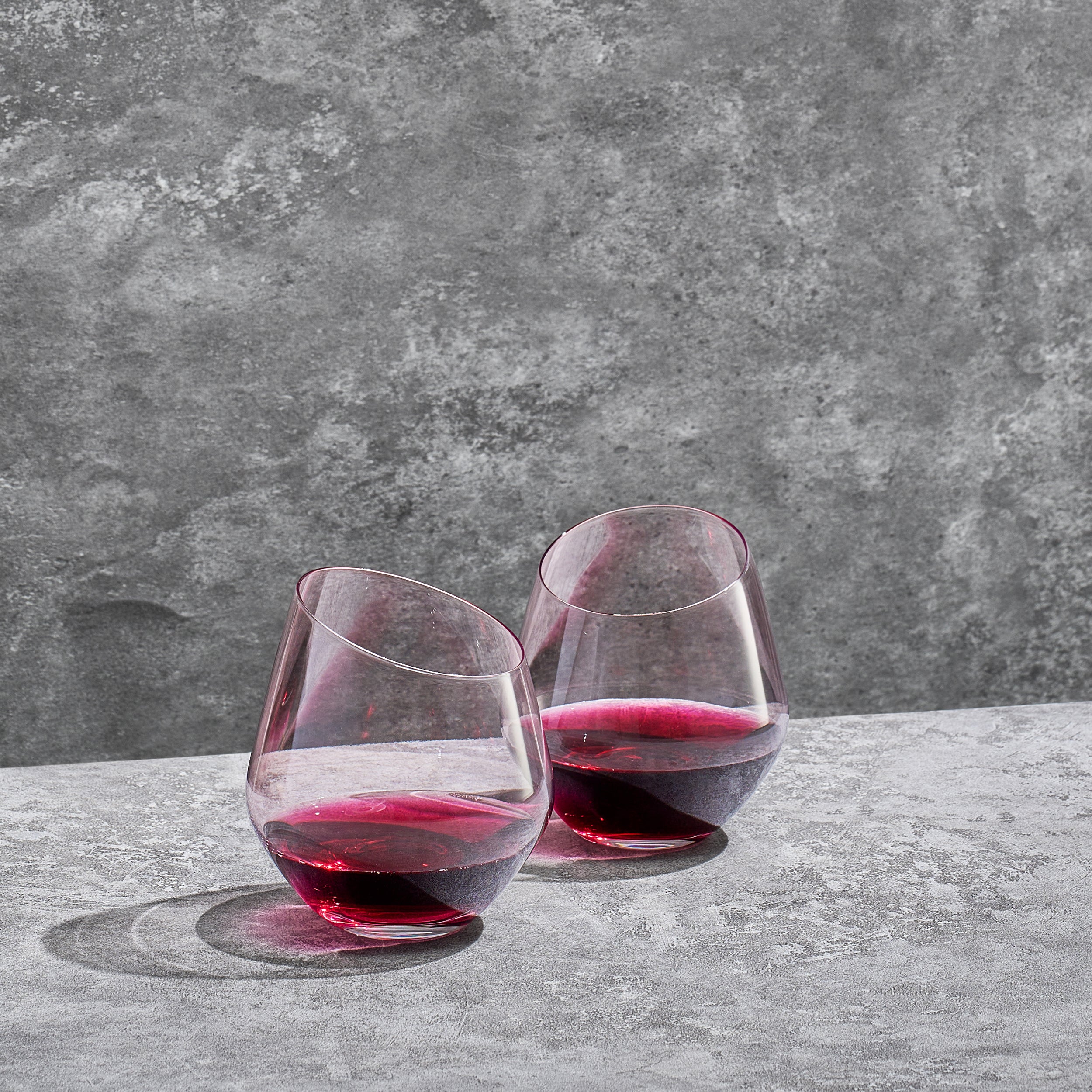 14 oz stemless wine glass filled with red wine