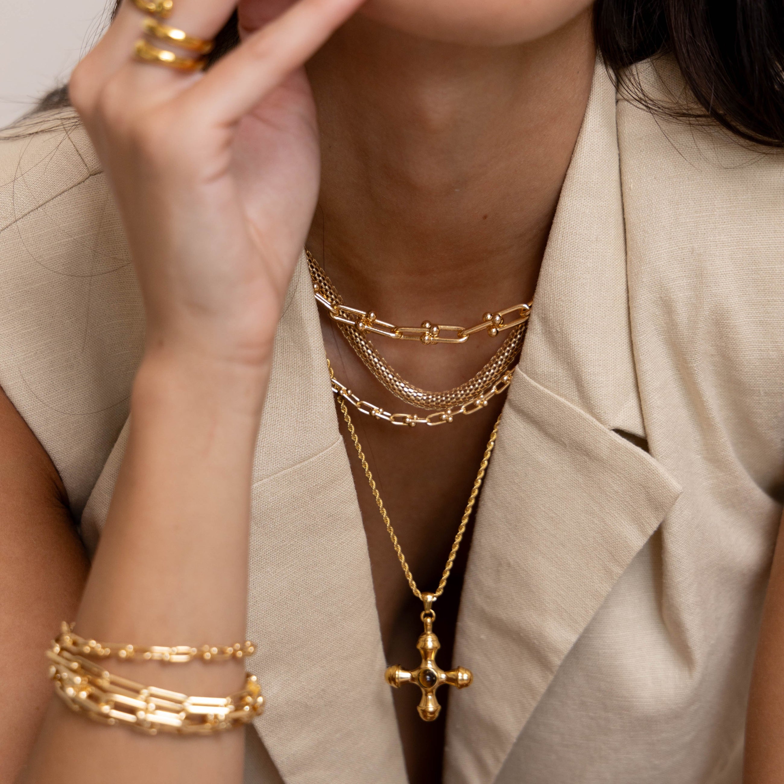 Model wearing Sandra Mesh Choker layered with other gold necklaces