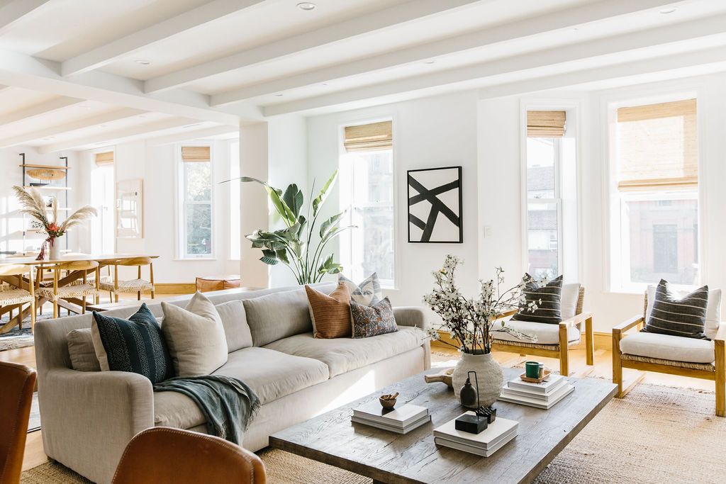 designer pillow covers with neutral sofa in living room.