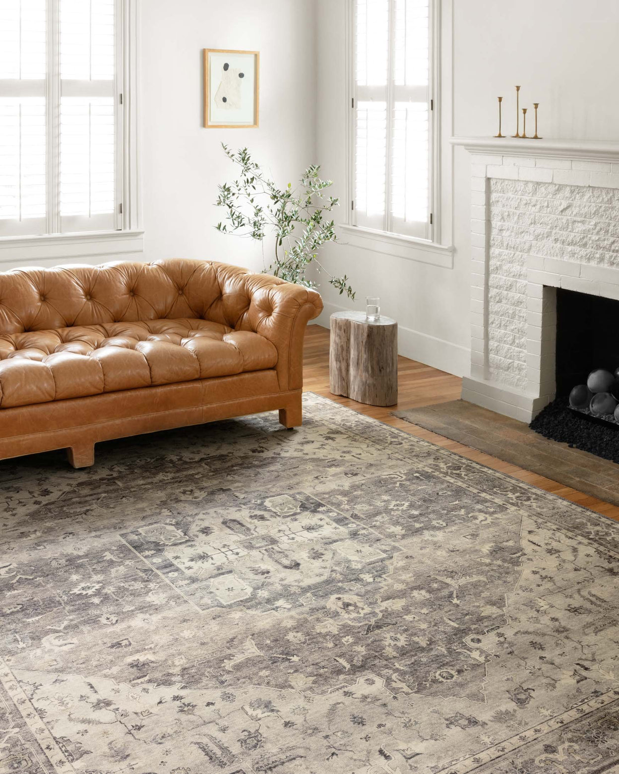 Rug in a living room area with a couch and fireplace