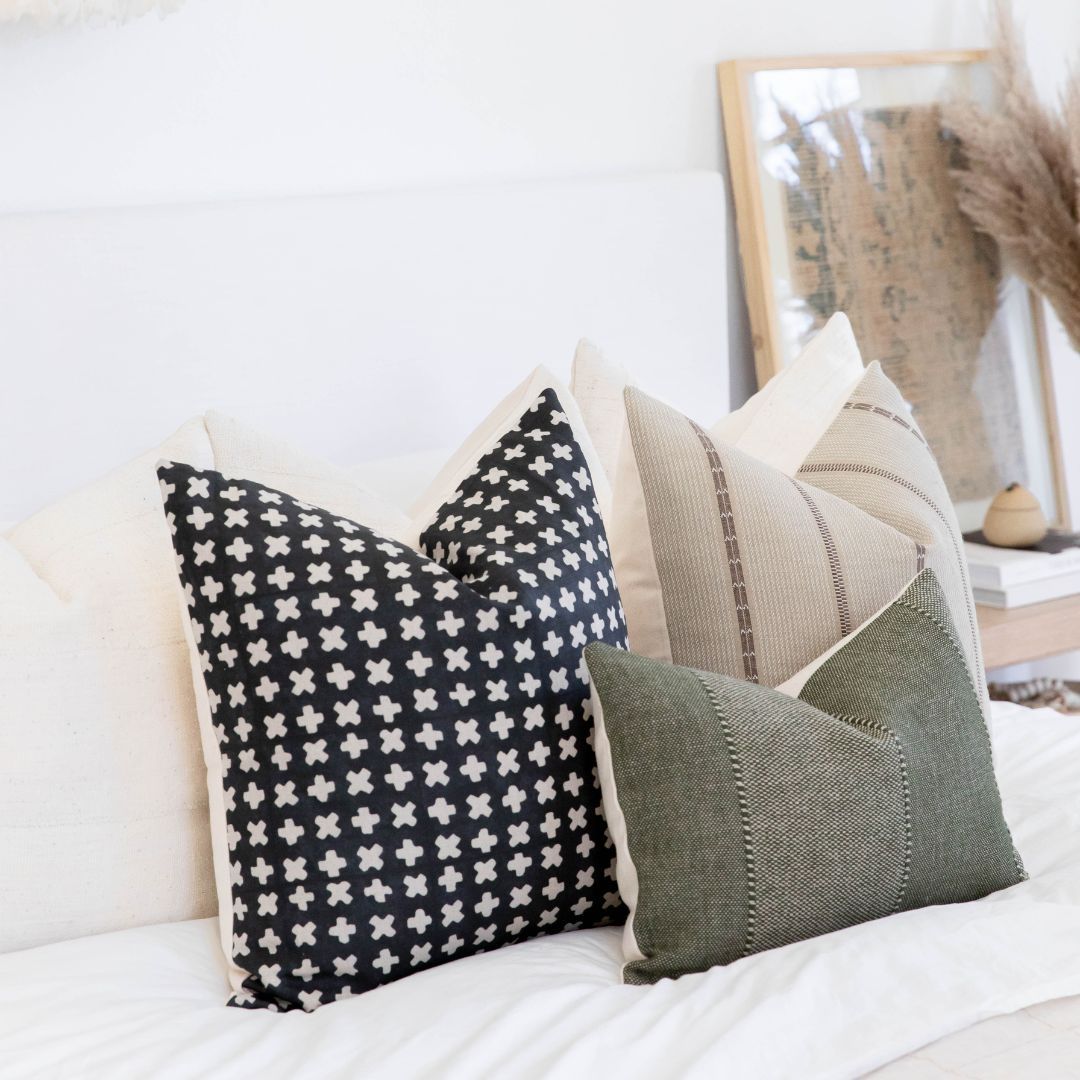 Throw Pillow set resting on a white bed