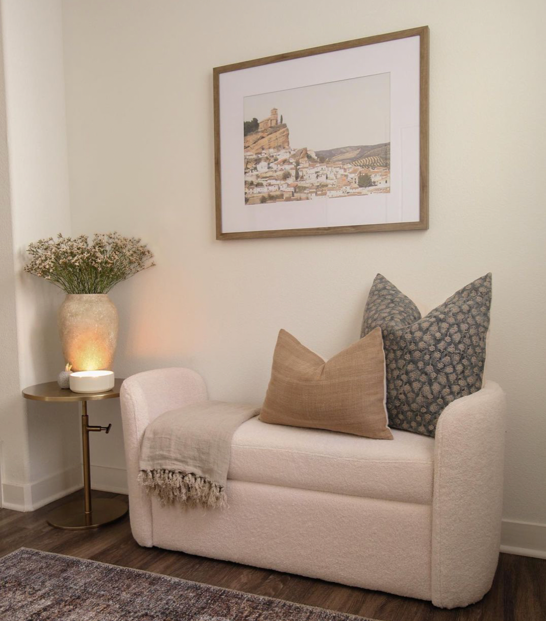 white couch in hallway with gray and tan throw pillow