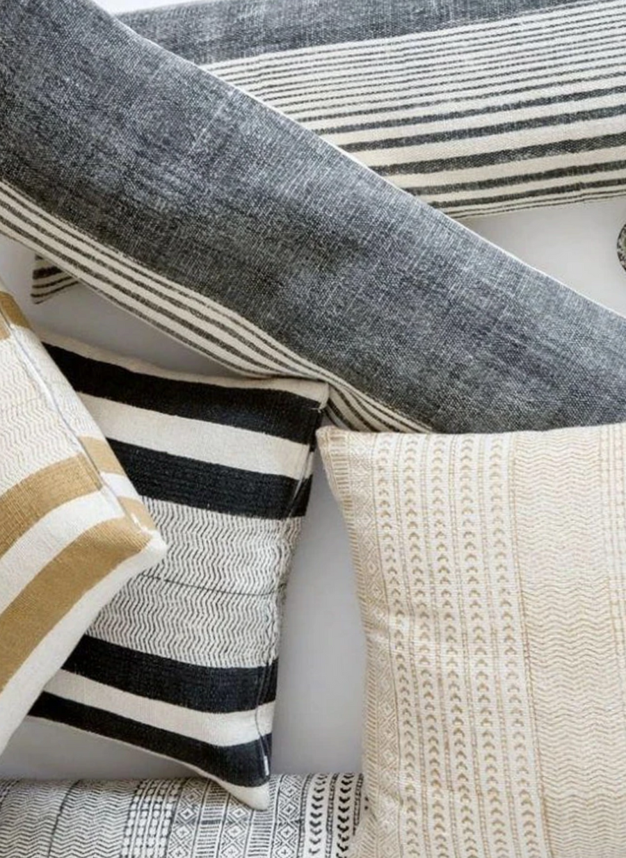 Various Throw Pillows resting on a bed