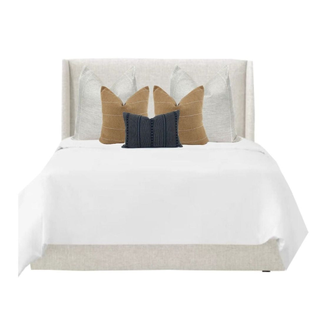 Euro pillows layered on a king bed with One Affirmation pillow covers