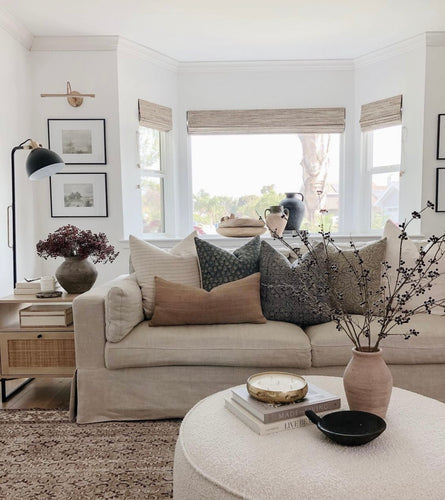 tan couch with a fall pillows