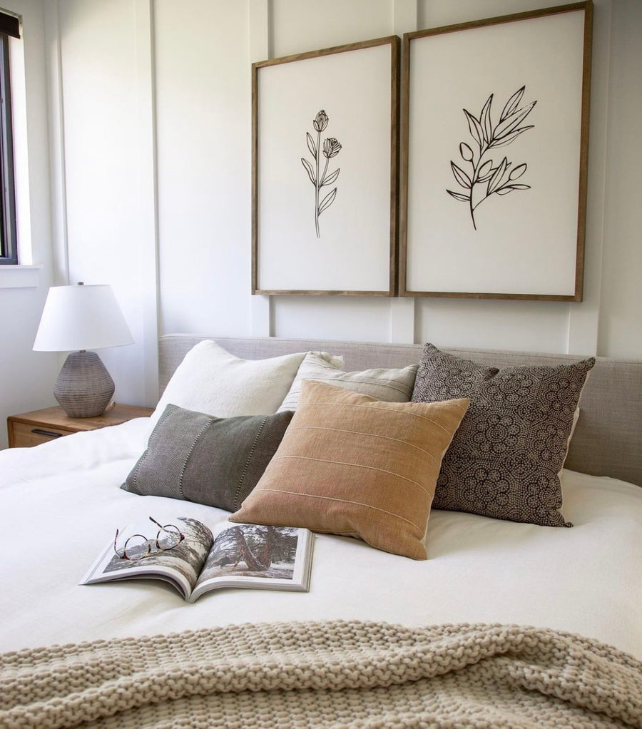fall pillows on white bed 