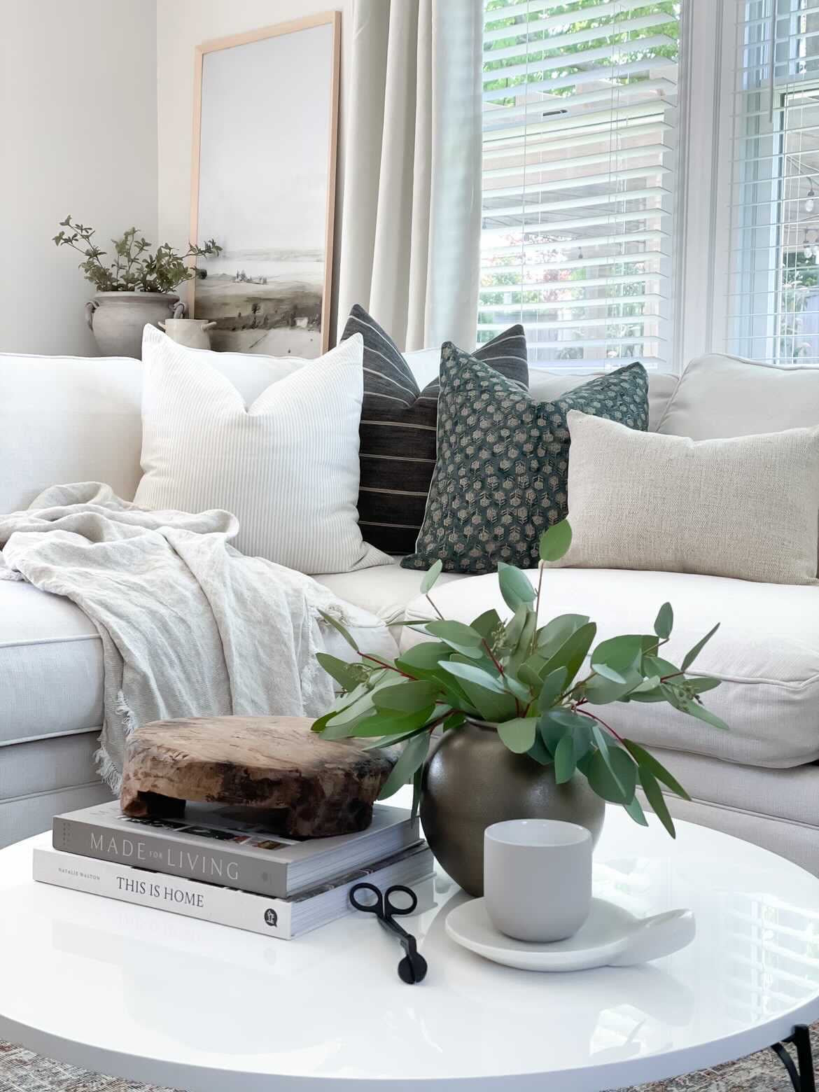black, white, and gray throw pillows on white couch