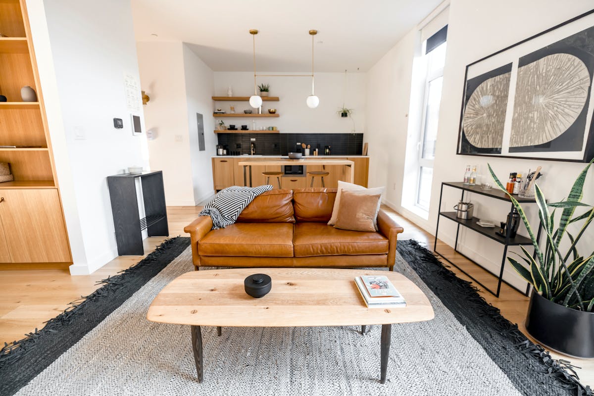 a room full of furniture with pillows and throw rugs