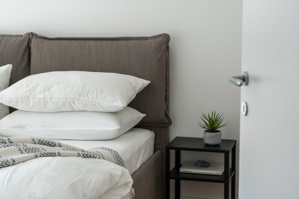 a bed with a bunch of pillows on it