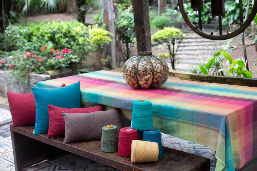 a table with a bunch of decorative pillows in front of it