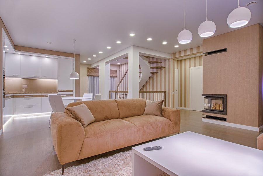 a massive living room with a sofa that has pillows on it