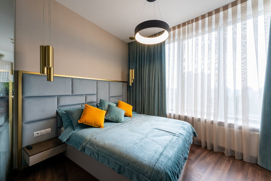 a bed in a nice room with a bunch of decorative pillows on it