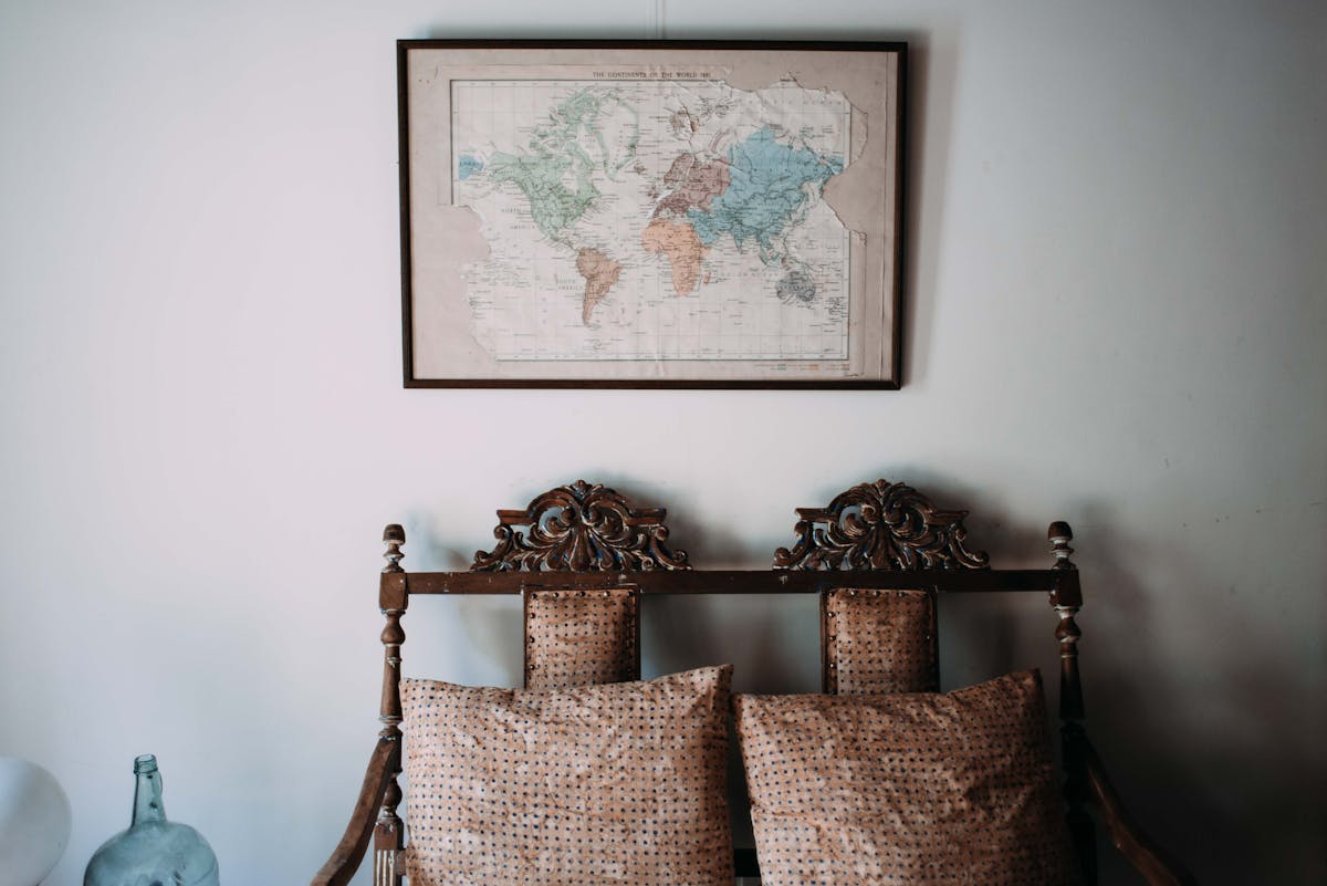 a seat with a bunch of vintage pillows on it
