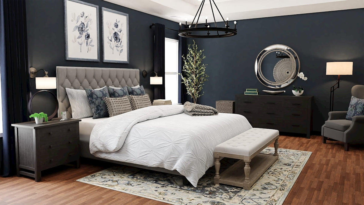 decorative pillow arrangement on modern bed with moody bedroom paint.