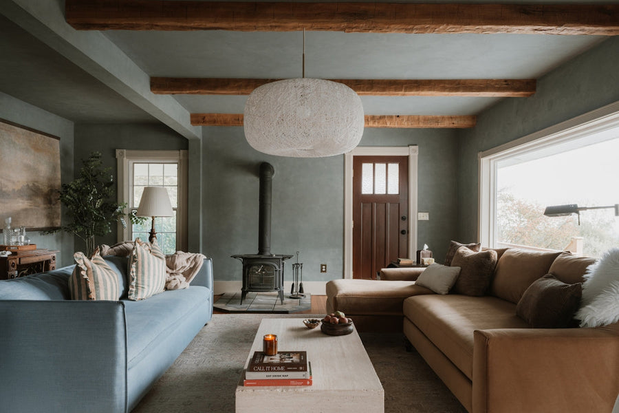 Cozy living room with sectional sofa and wood stove.