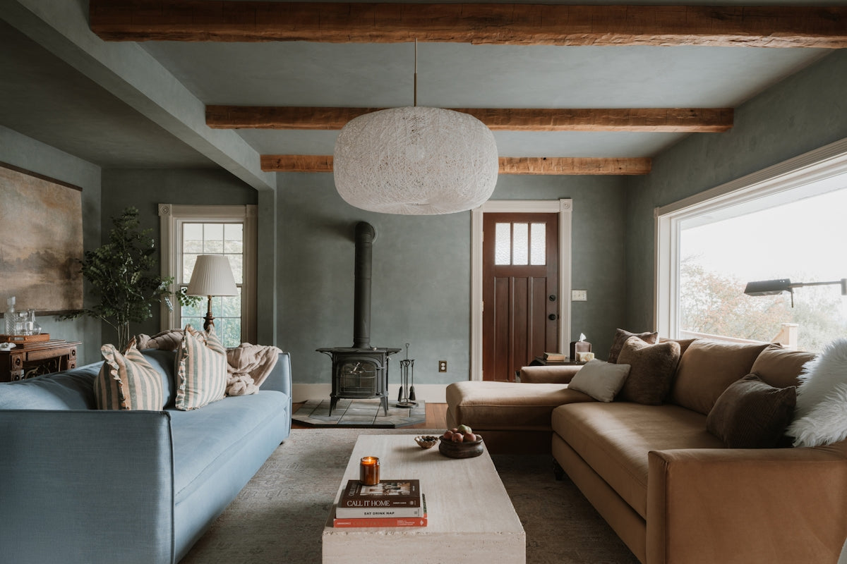 Modern Moody living room with sectional sofa and wood stove.