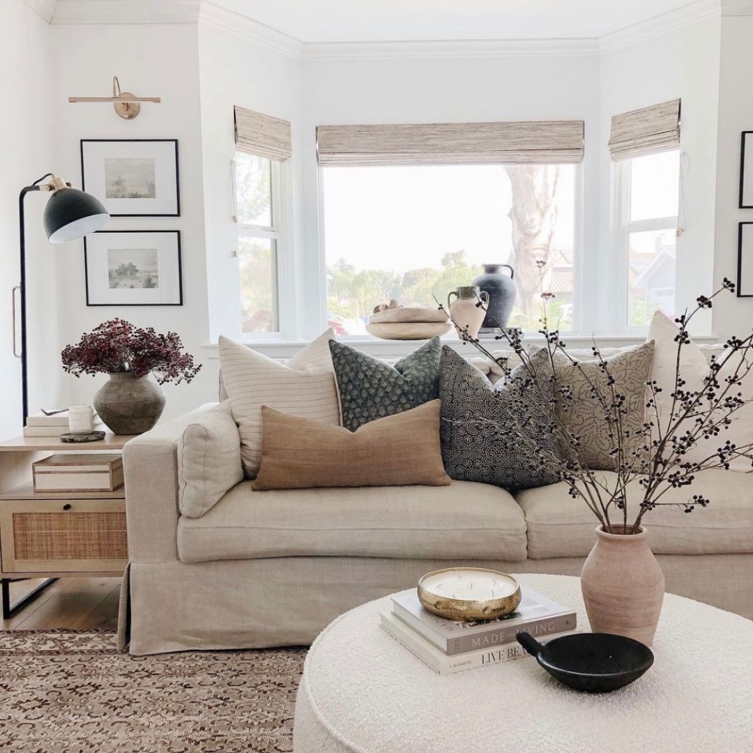 Living Room containing a couch with various throw pillows on it