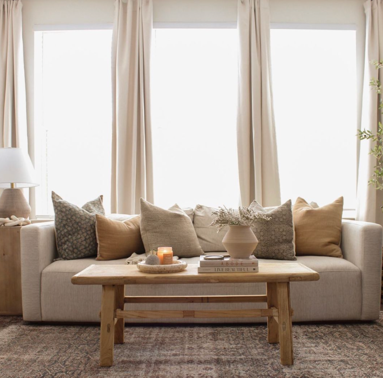 a couch with a bunch of designer throw pillows on it