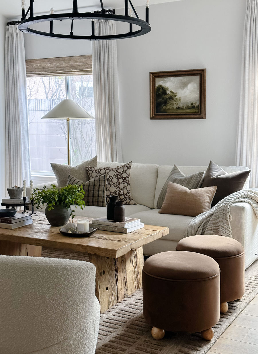 designer pillow covers with rusts and brown on cream sofa in bright and airy living room