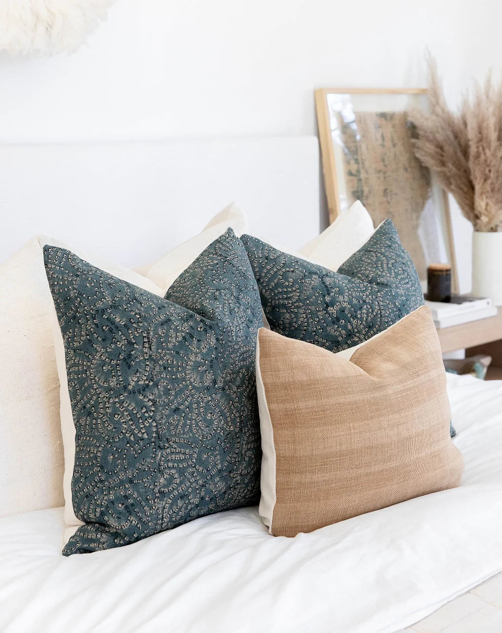 Decorative pillow covers on a white bed made by One Affirmation