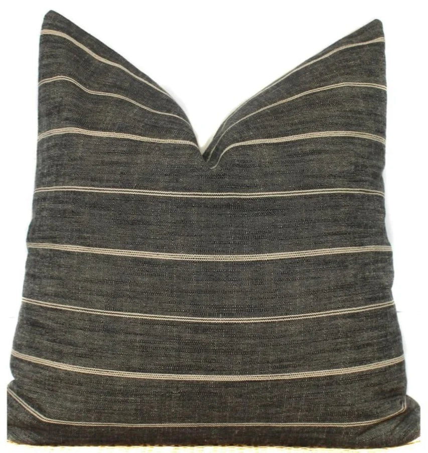 Dark grey stripe designer pillow cover styled on a sofa