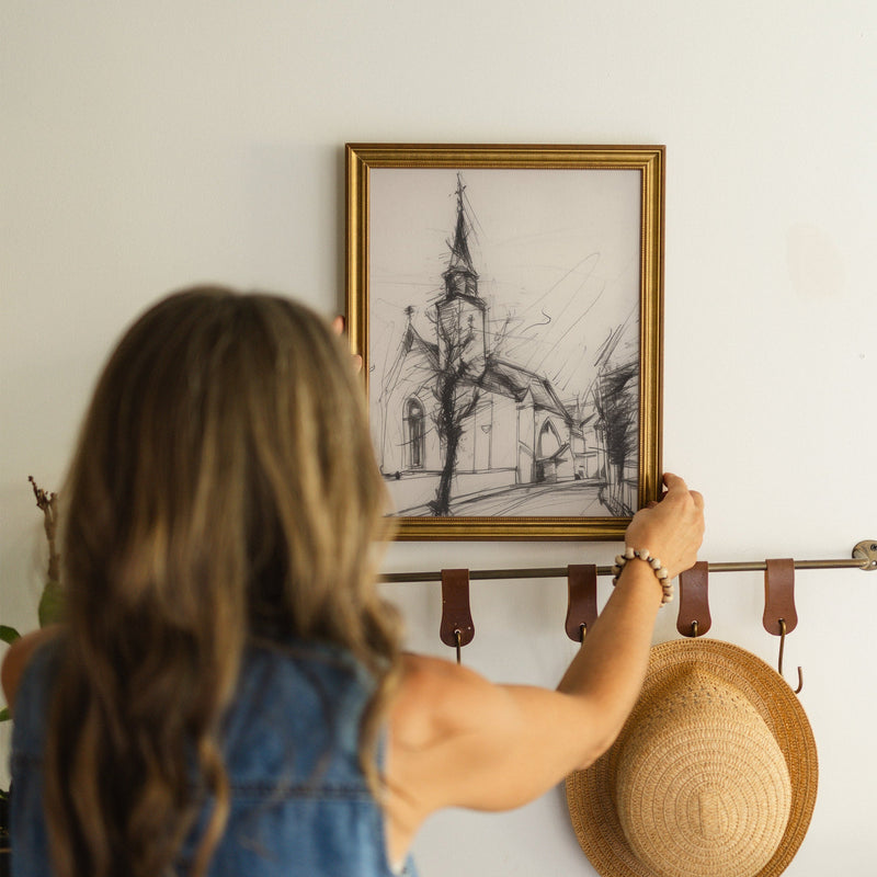The Village Chapel framed canvas art styled in a home interior