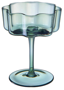 Muted tone cocktail coupes styled in bar cart setting