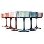 Set of 6 muted color flower coupe glasses on table