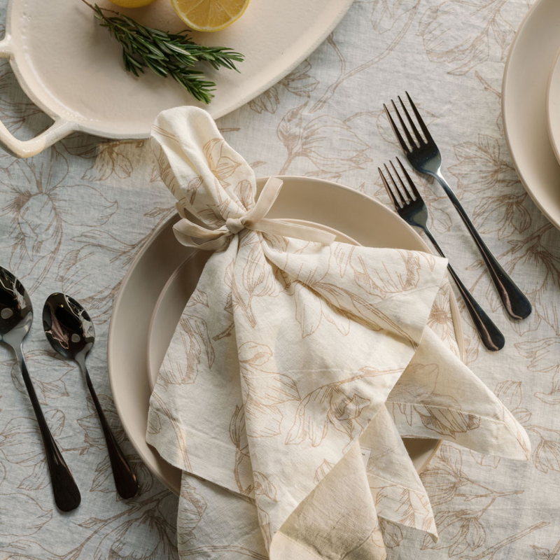 Handcrafted blush lilies napkins styled on dining table