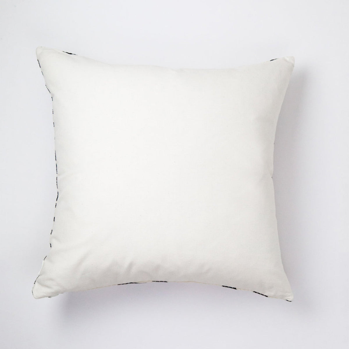 Back of the checkered brocade pillow in green and cream