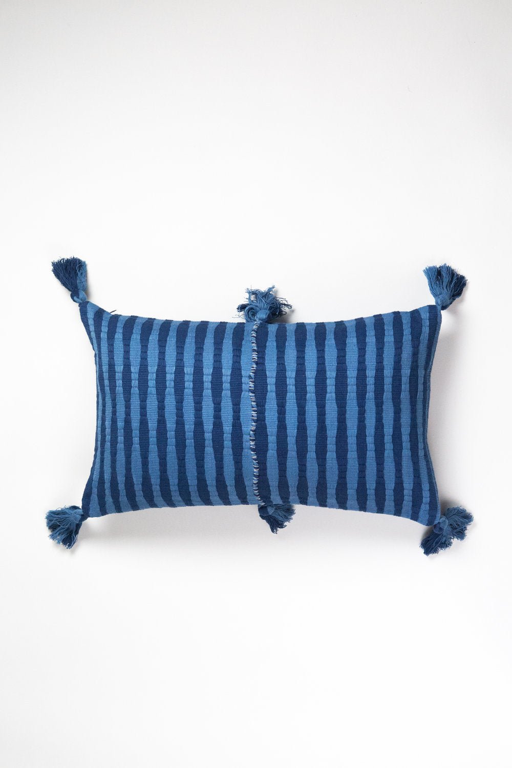 Front of the 12x20 Antigua lumbar pillow in natural indigo stripe