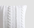 Decorative braided cushion styled on sofa