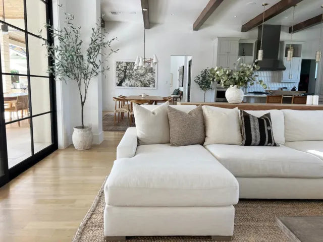 Modern living room styled with a white sectional sofa and neutral decorative pillow covers by One Affirmation