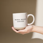 Close-up of coffee mug with black lettering and natural base