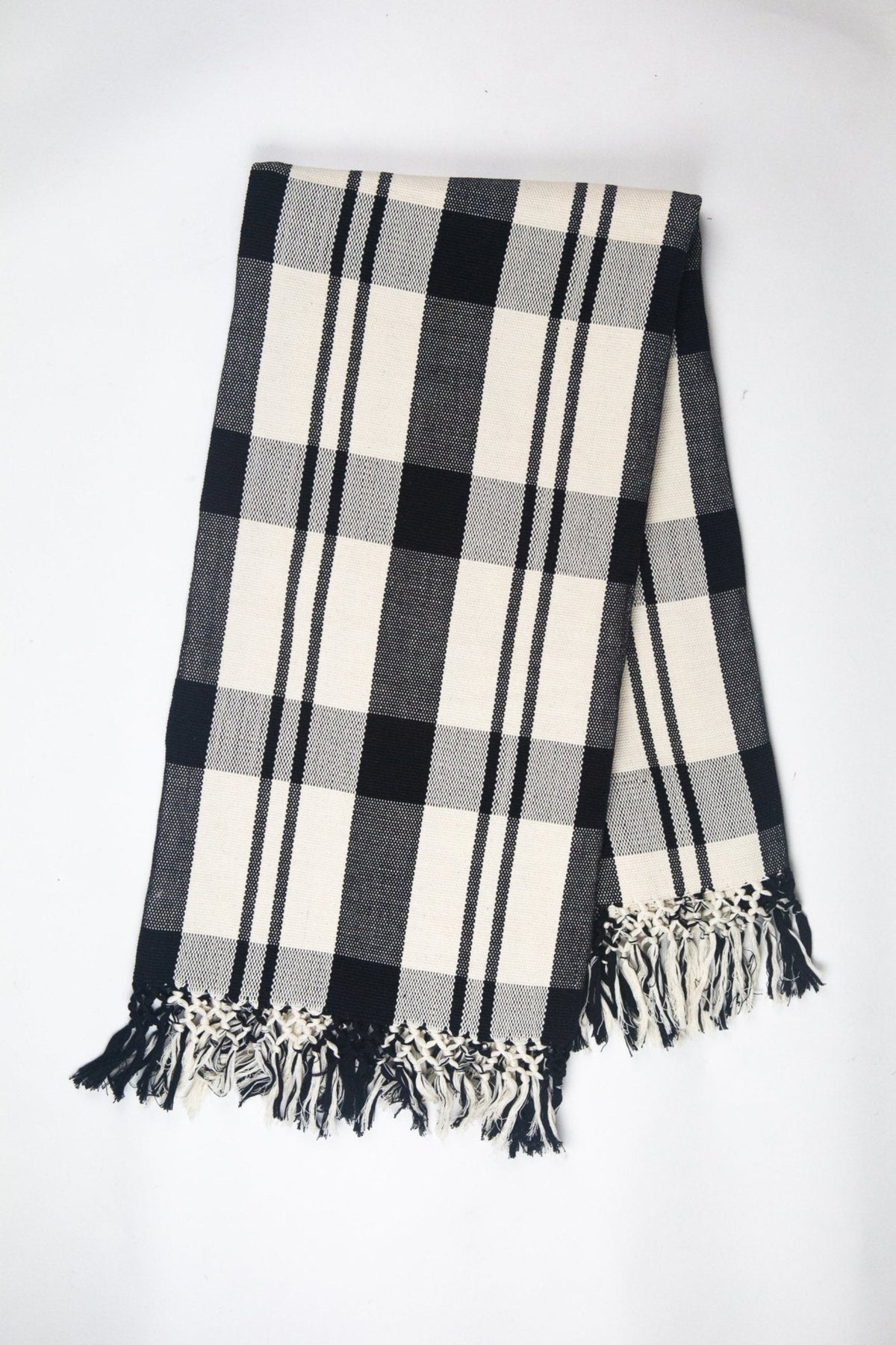 Cecilia black and white cotton throw showing the hand-embroidered randa