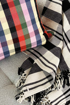 Cecilia black and white striped cotton throw blanket styled in a home interior