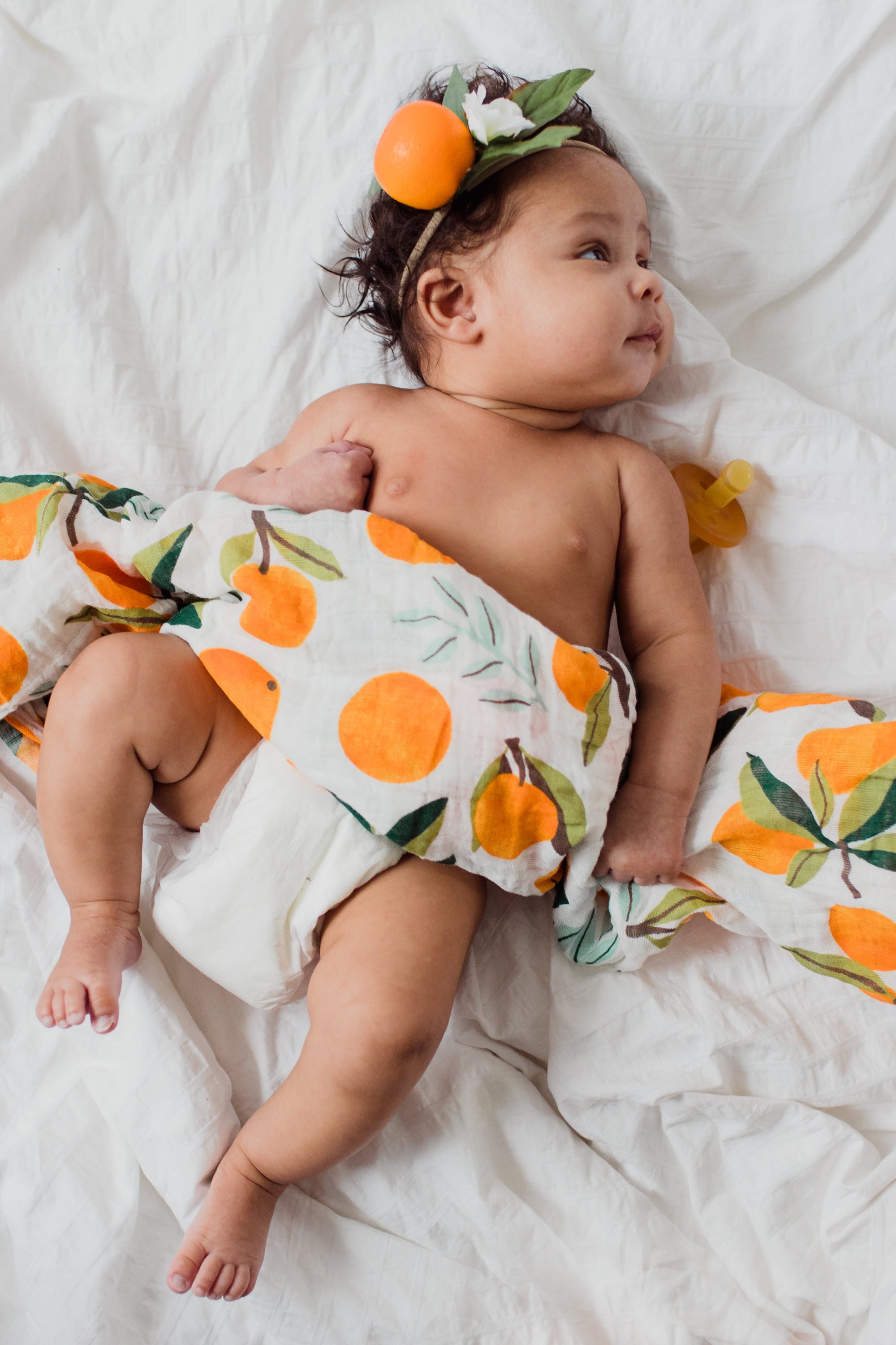 Clementine Kids citrus swaddle styled in nursery