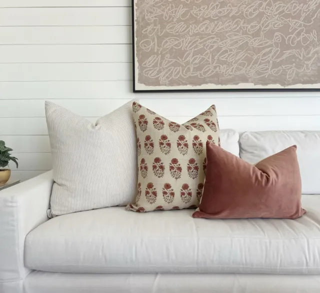 Neutral living room sofa styled with One Affirmation designer pillow covers in textured and patterned fabrics.