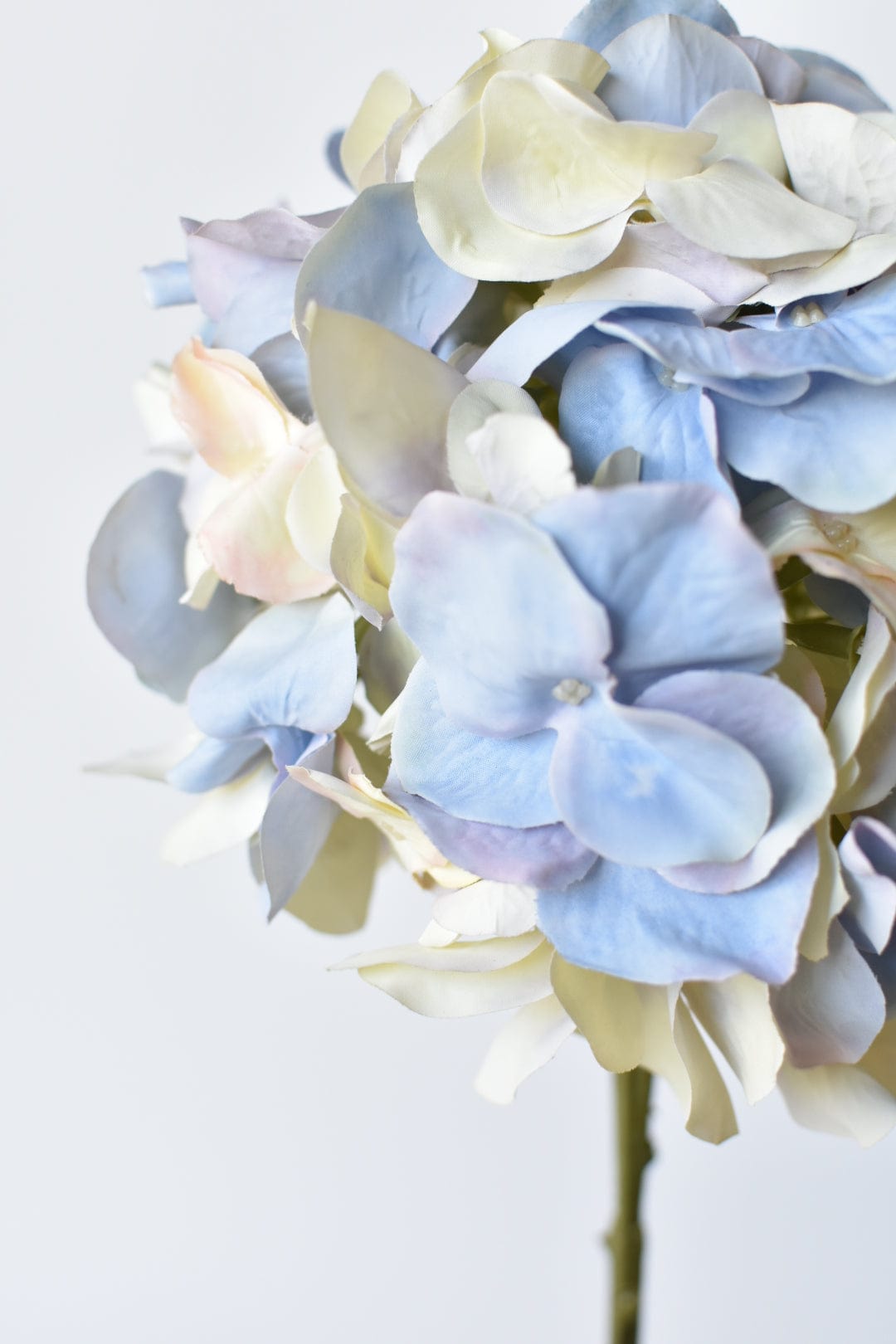 Artificial hydrangea stem with soft pastel-colored flowers