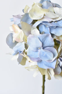 Artificial hydrangea stem with soft pastel-colored flowers