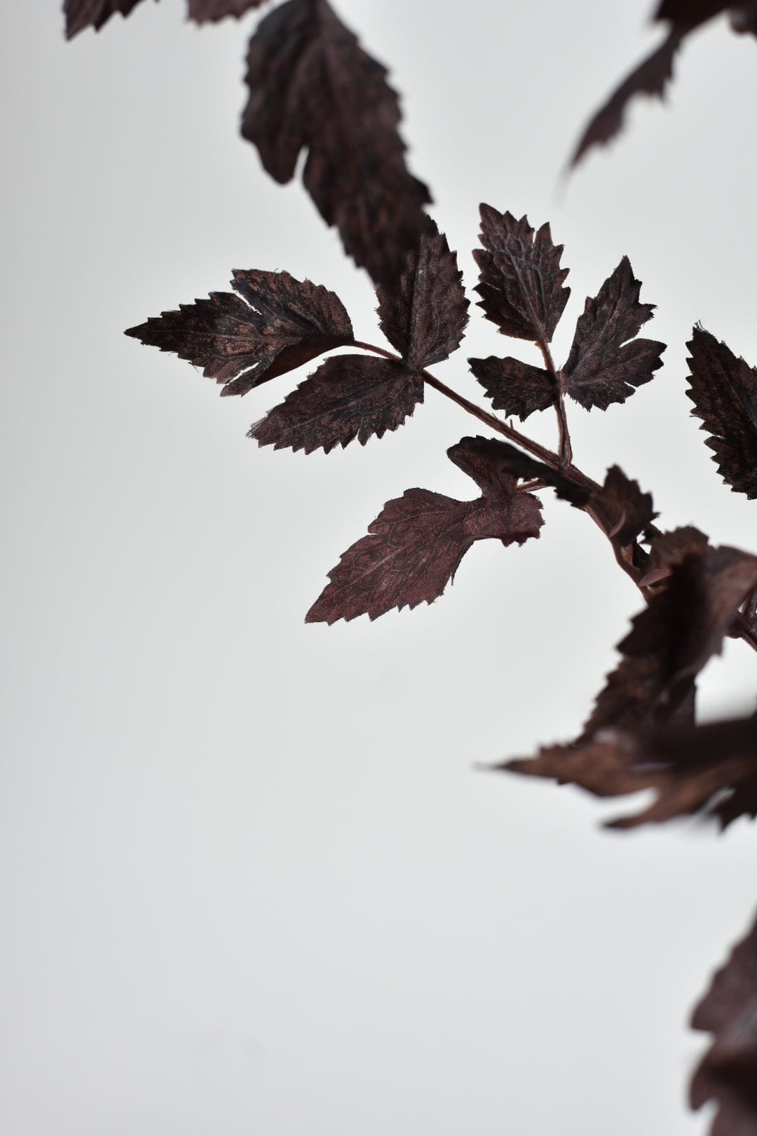 Artificial purple foliage branch for autumn arrangements