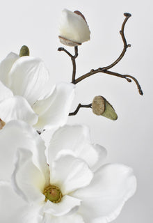 Artificial magnolia stem styled in bud vase