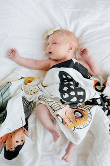 Cotton muslin swaddle folded to show butterfly design