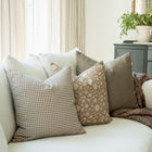 Madeleine taupe botanical pillow styled in a living room